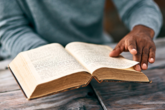 Image of a person reading the Bible.